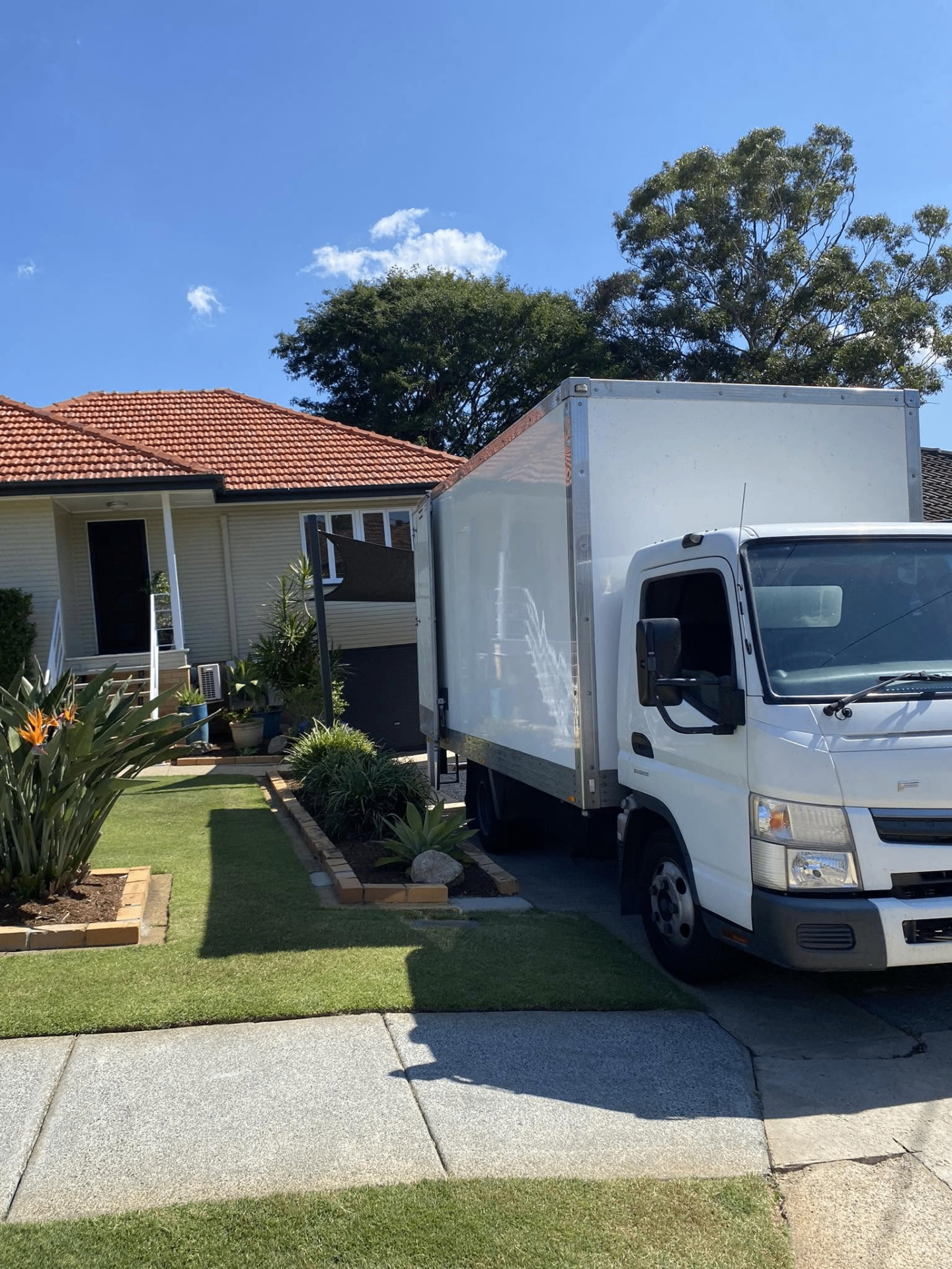 Silky Movers truck unloading at a Brisbane family home